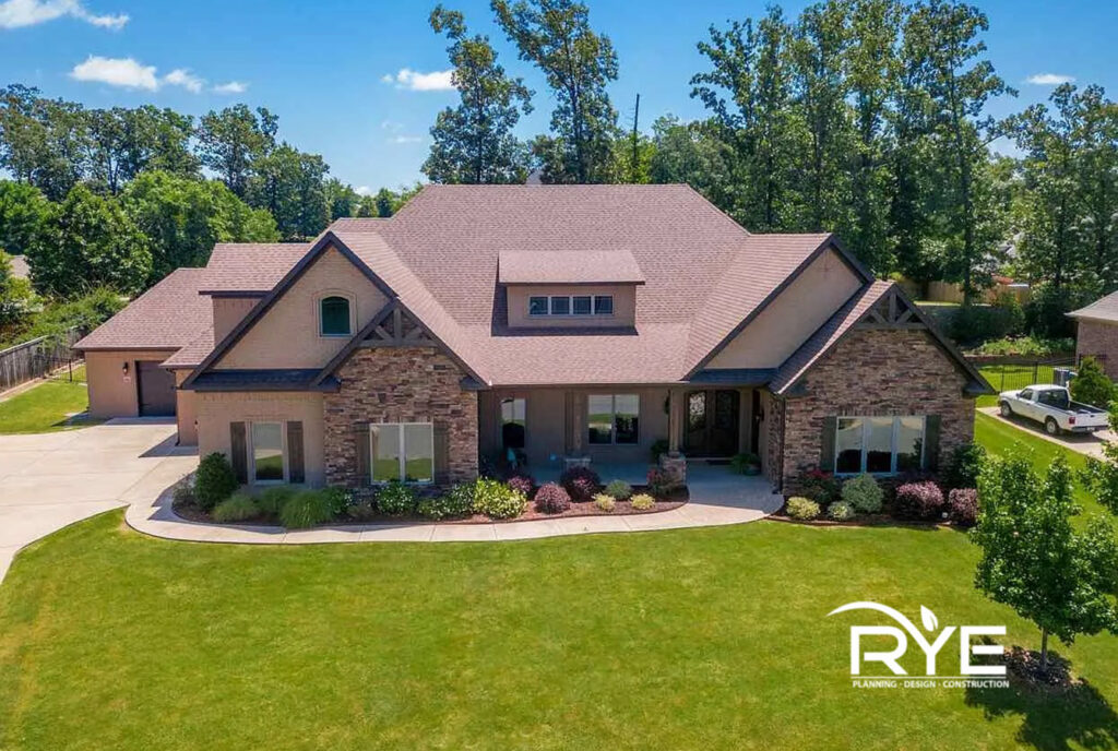 Central Arkansas custom home with layered rooflines, covered porch, and timeless exterior design